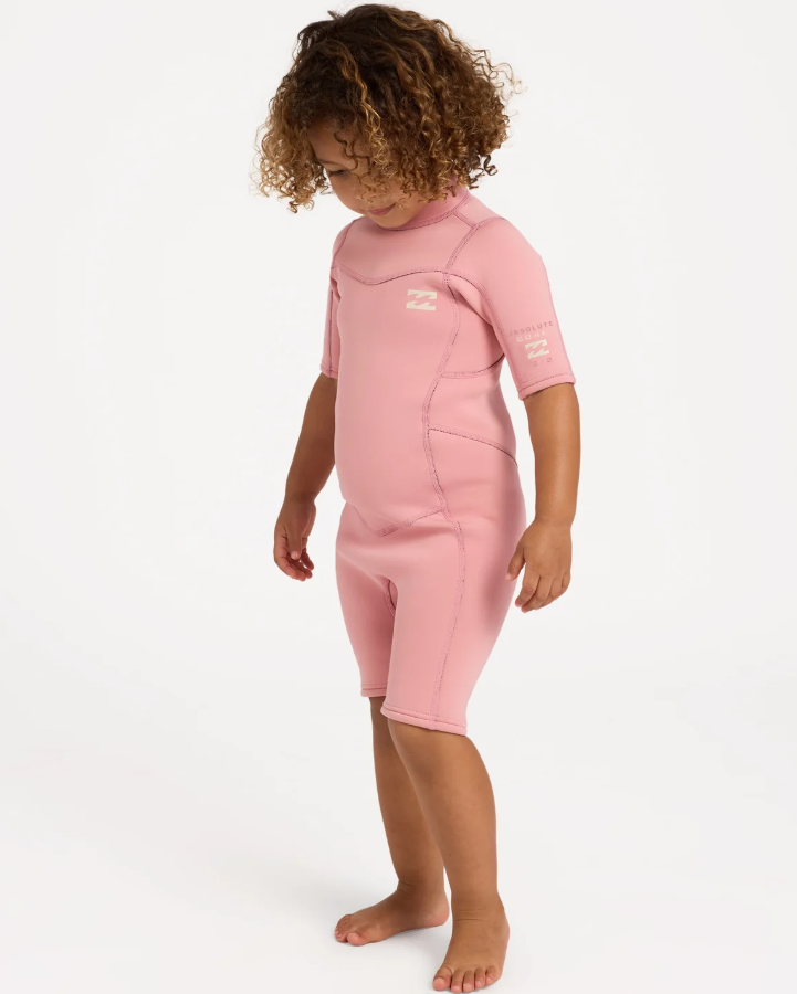 Billabong 2/2mm Absolute Spring Toddler Wetsuit in french rose colourway on model from the side