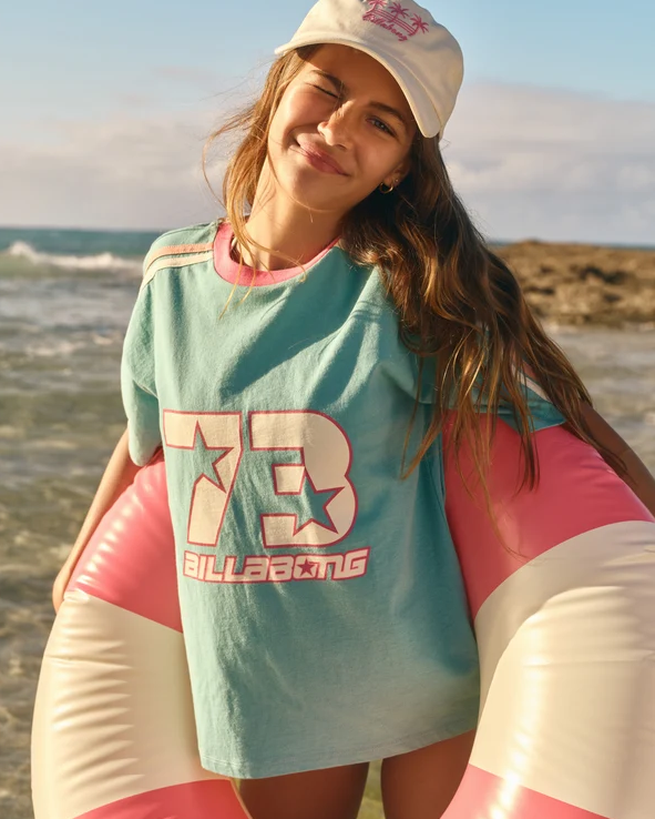 Billabong Billa Star Girl's (8-16) T-Shirt in misty blue colourway on teen model at beach in inflatable ring