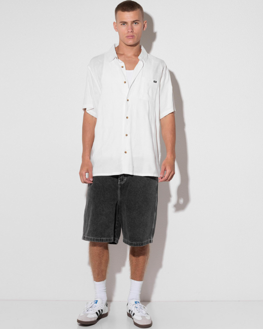 Billabong Sundays Jacquard Short Sleeve Shirt in white on model in black denim shorts from the front