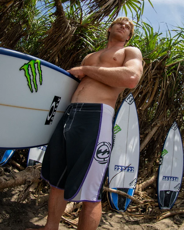Billabong Spec Dbah Pro 21" Men's Boardshorts in black and white on model at the beach
