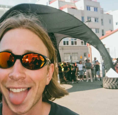 CHPO Brand Nori Unisex Sunglasses in coffee colourway with red ion lenses on male model outside a tent