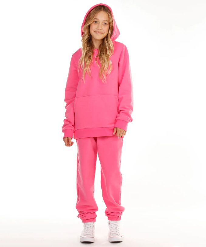 Hello Stranger Seagirl Isla Girls Hoodie in flamingo colourway on model in hello stranger trackpants from front