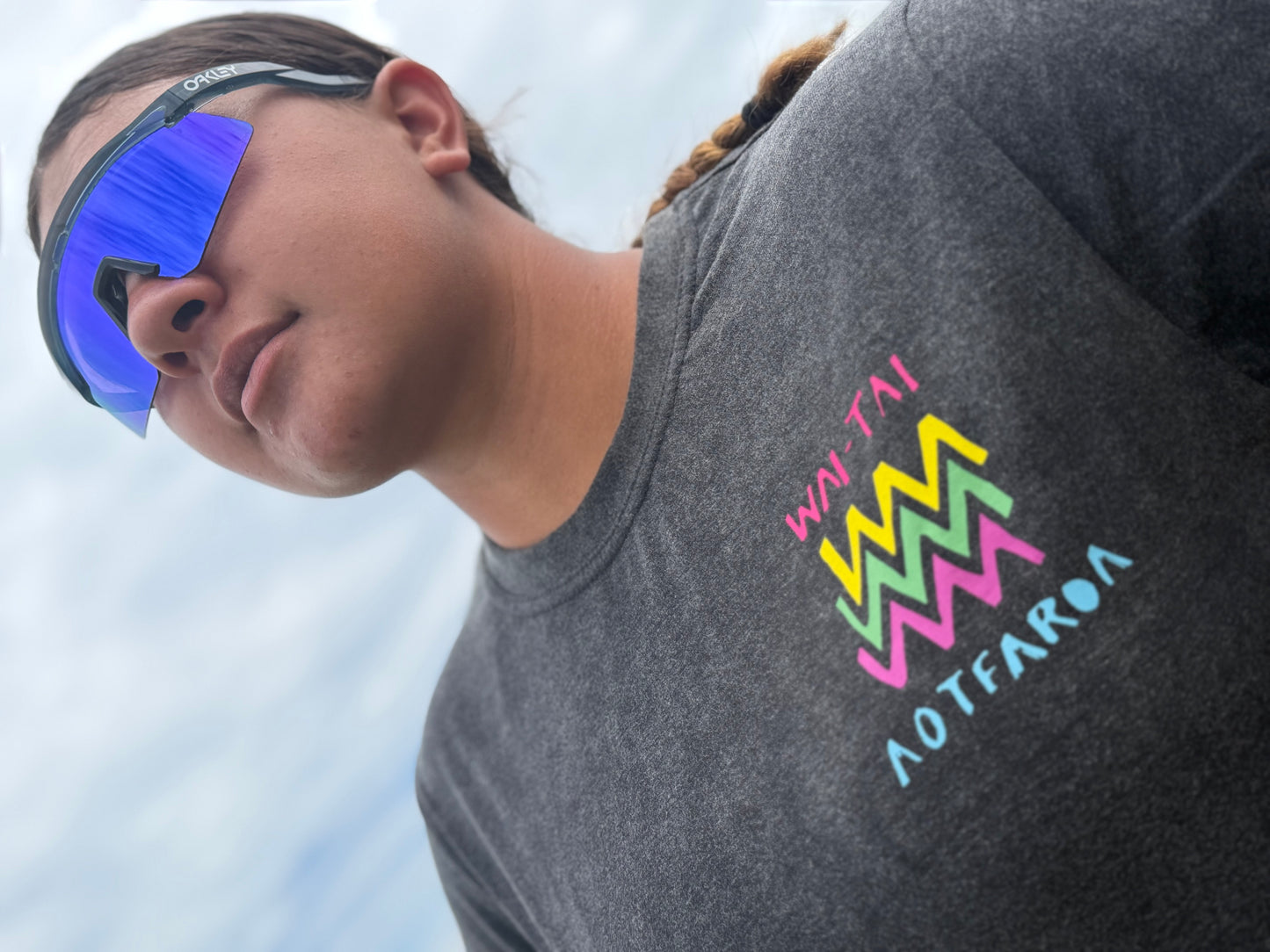 Wai-Tai Aotearoa Ono Whitu Unisex Stonewash Tee from front showing bright logo on Hine Brooking