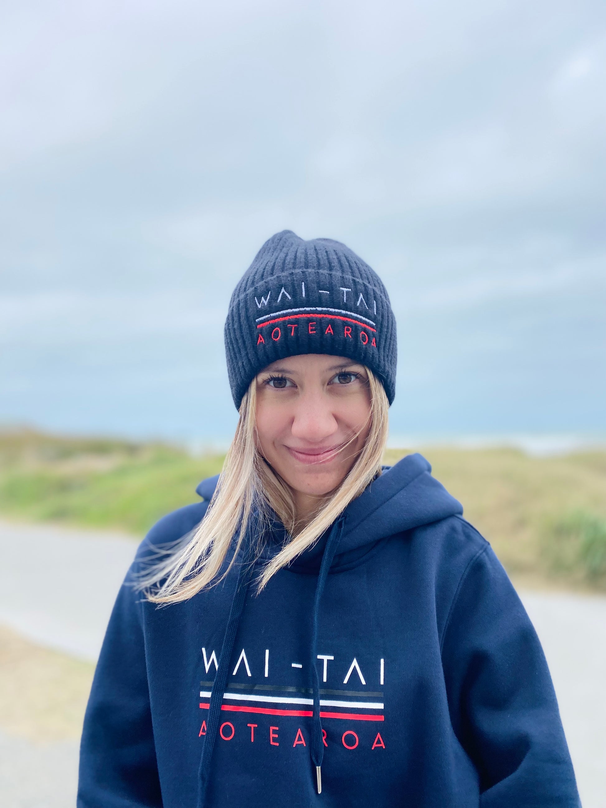 Wai-Tai Aotearoa Tohu Fisherman Beanie in black on model from front
