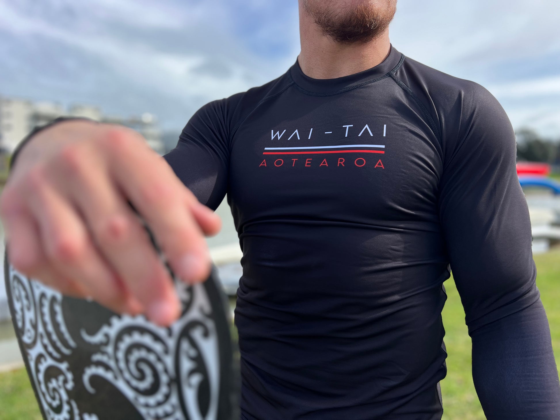 Wai-Tai Aotearoa Patiki Thermal Longsleeve Rash Top from front angle in black