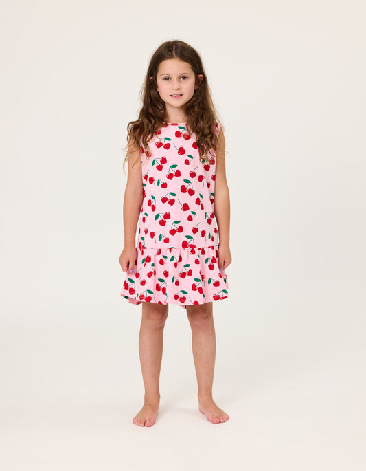 Kissed By Radicool Cherries Sleeveless Frill Dress in pink with red cherry print on girl model from front