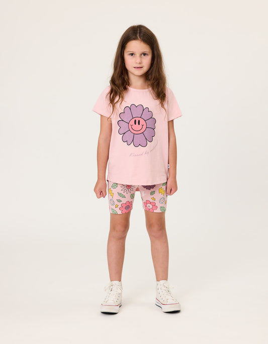Kissed By Radicool Smiley Flowers Bike Shorts on dark-haired model wearing pink tee from front