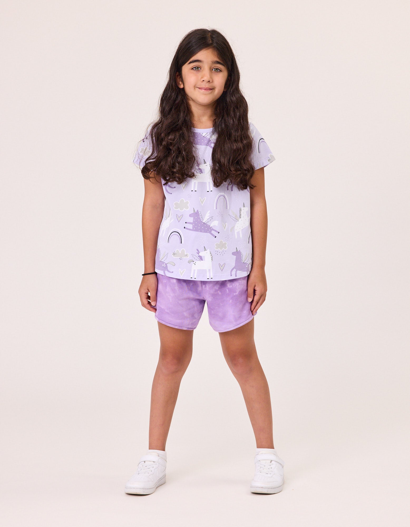 Kissed By Radicool Magical Unicorns T-Shirt in purple with unicorn print on model from the front