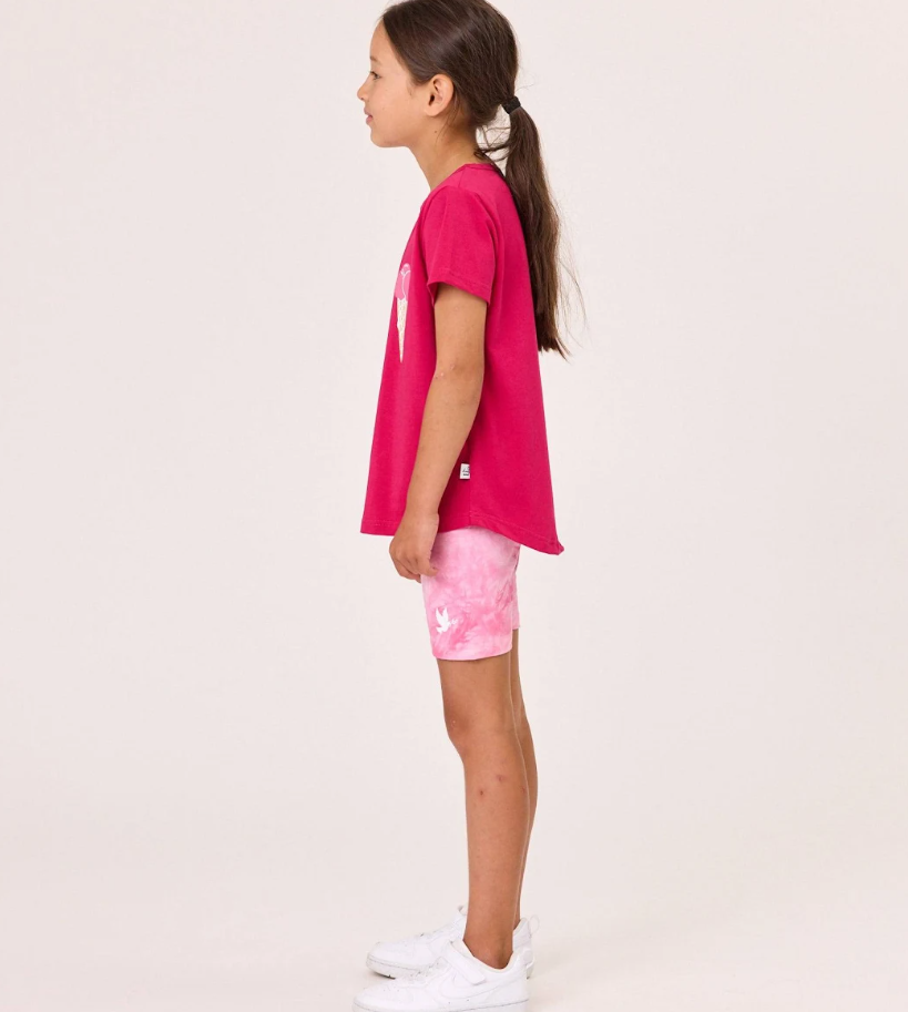Kissed By Radicool Bike Short Tie Dye Pink on model in pink tee with ice creams on it from the side