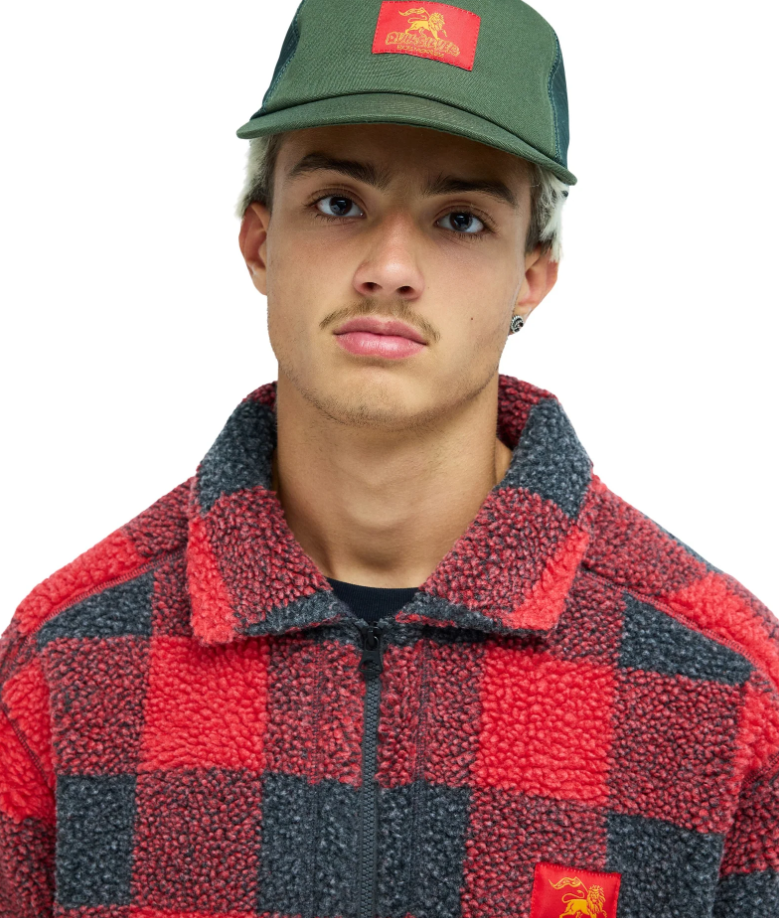 Quiksilver Bob Marley Drifter Trucker Cap in grape leaf green colourway on model in red and black Bob Marley jacket