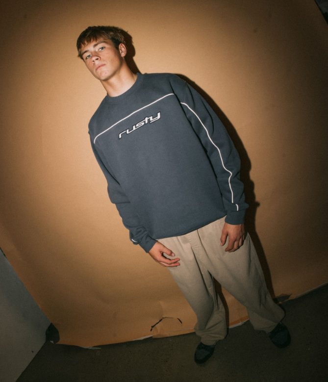 Rusty Trigger Men's Crew Fleece in atlantic blue on model with brown background