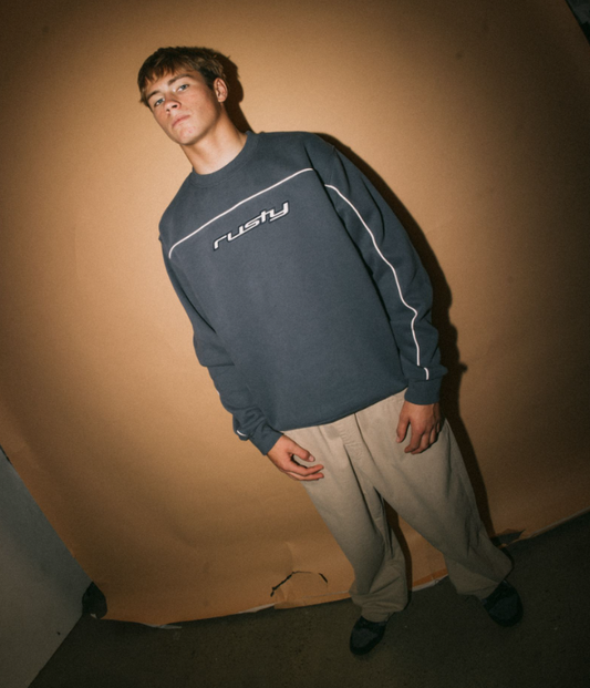 Rusty Trigger Men's Crew Fleece in atlantic blue on model with brown background