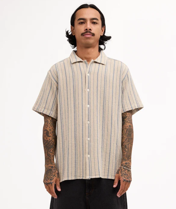 RVCA Vacancy Stripe Short Sleeve Shirt
  in light khaki on model from front