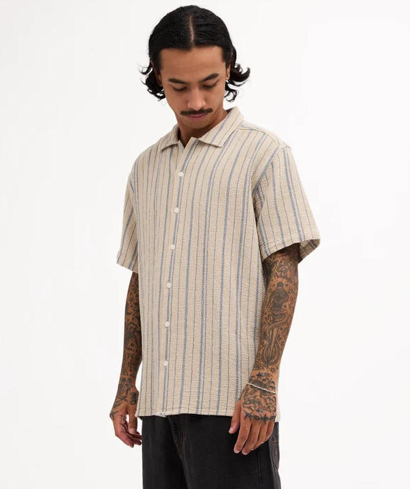 RVCA Vacancy Stripe Short Sleeve Shirt
  in light khaki on model from side