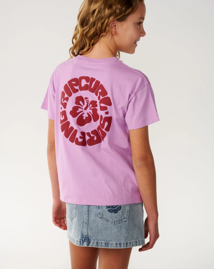 Rip Curl Surf Puff Relaxed Girls Tee
 in bright lilac colourway on young model in denim skirt from the back