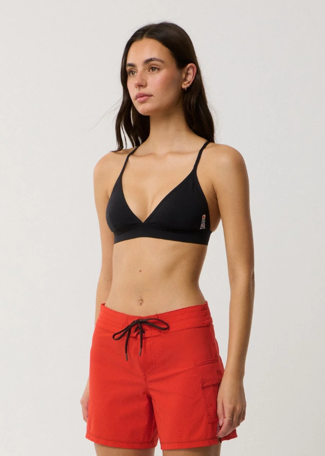 Rip Curl Surf Series Stretch 5" Tech Women's Boardshorts in red on model in black triangle bikini top
