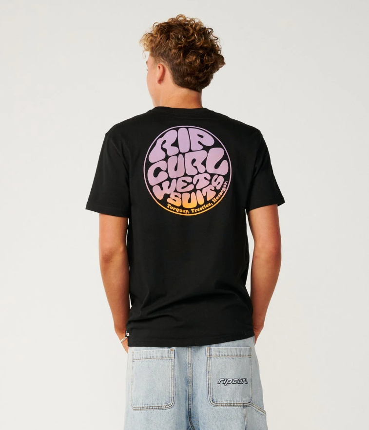 Rip Curl Wettie Passage Icon T-Shirt in black with purple and orange logo on model in light blue denim shorts from the back