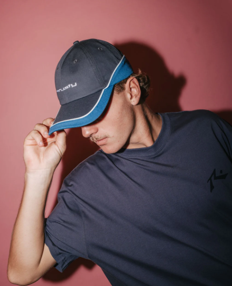 Rusty Double Dip Dad Cap in coal and blue colourway on model from front