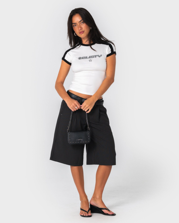 Rusty Roamie Star Fitted Baby Tee in egret white with black detailing on model from the front