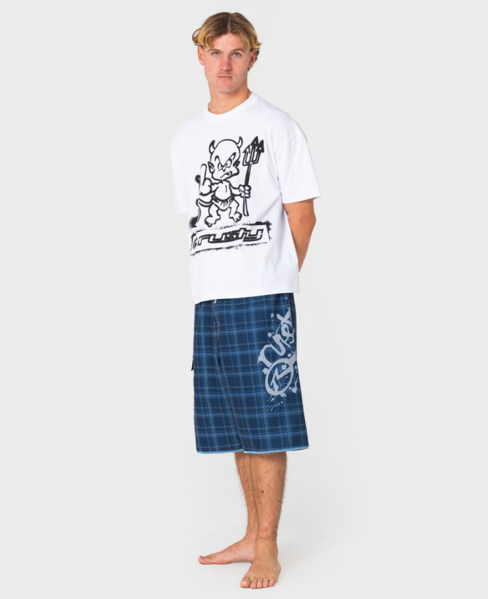 Rusty Scribbla 24" Fixed Waist Boardshorts in navy showing large left Rusty print on model in white Rusty tee