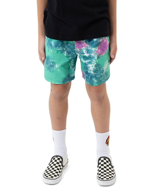 Person wearing tie-dye shorts with a white background