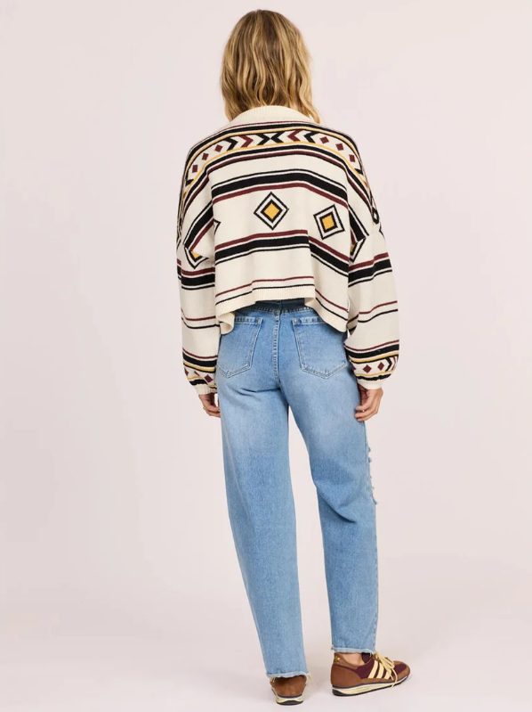 Sisstrevolution Ibiza Island Sweater in sea salt colourway on model in blue jeans from rear view