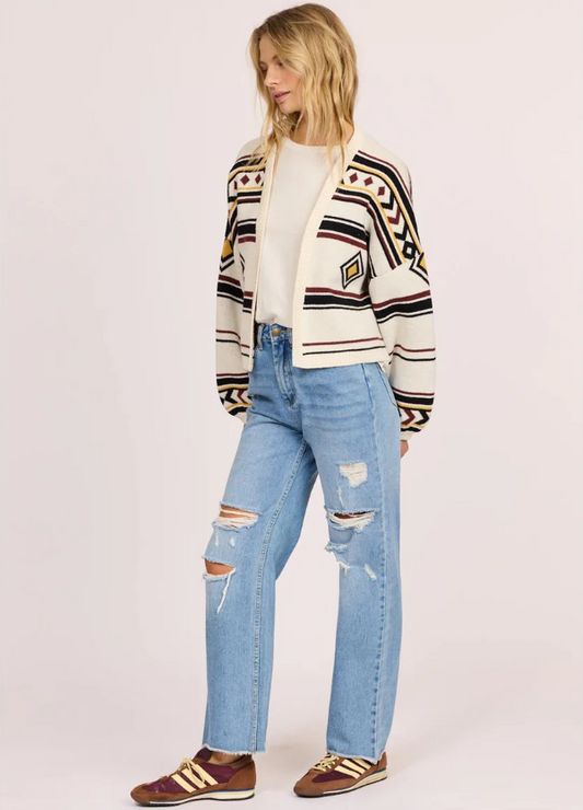 Sisstrevolution Ibiza Island Sweater in sea salt colourway on model in blue jeans from front/side view