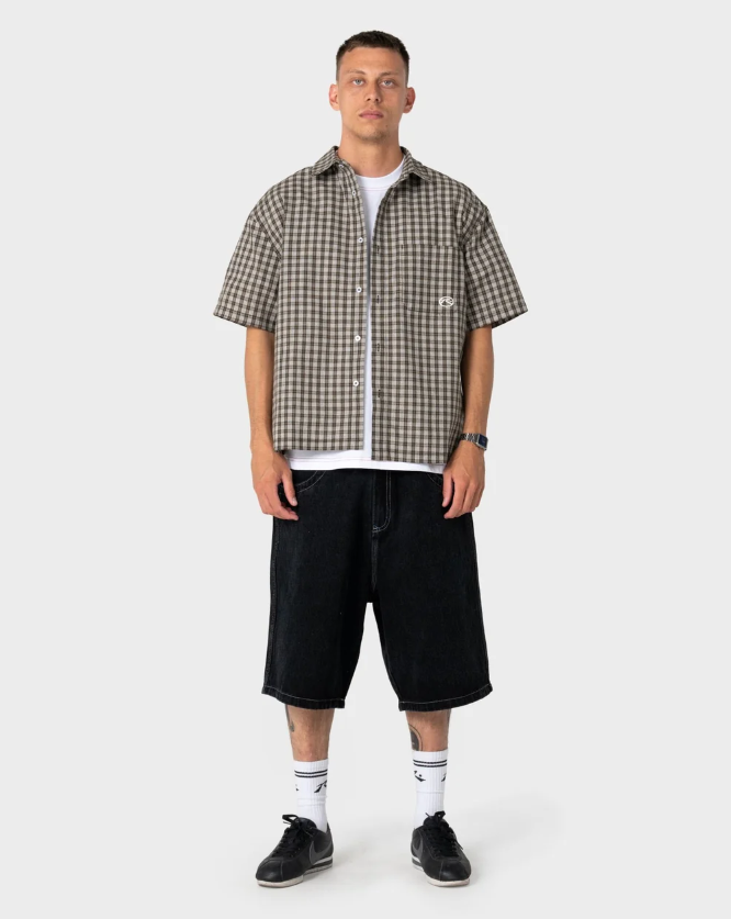 Rusty Anarchy Short Sleeve Shirt in savannah colourway on model in black denim shorts from the front