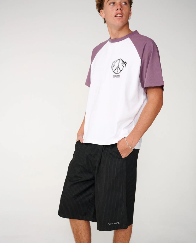Rip Curl Archive TWU Pinny 23" Walkshorts in black pinstripe on model in white and purple tee from the side