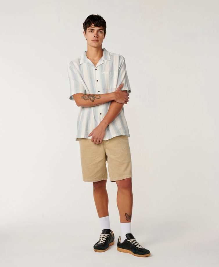 Rip Curl Classic Surf Weaver Short Sleeve Shirt in bone colourway with light blue vertical stripes on model in khaki walkshorts