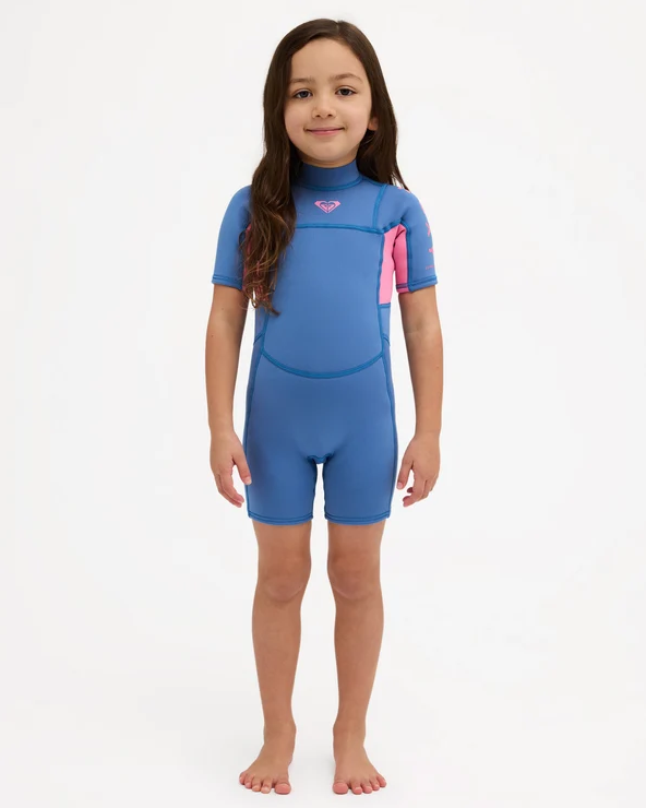 Roxy Prologue 2mm Girls Toddler Wetsuit in dutch blue colourway with pink panels on model from the front