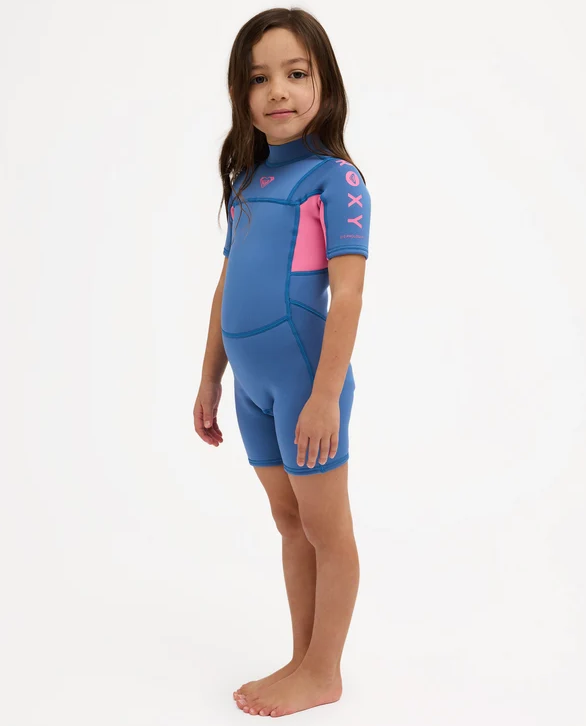 Roxy Prologue 2mm Girls Toddler Wetsuit in dutch blue colourway with pink panels on model from the side