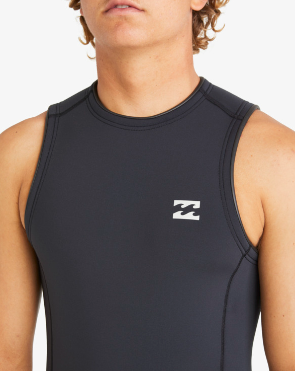 Billabong Absolute 2mm Short John Wetsuit in black on model from the front close up of the chest