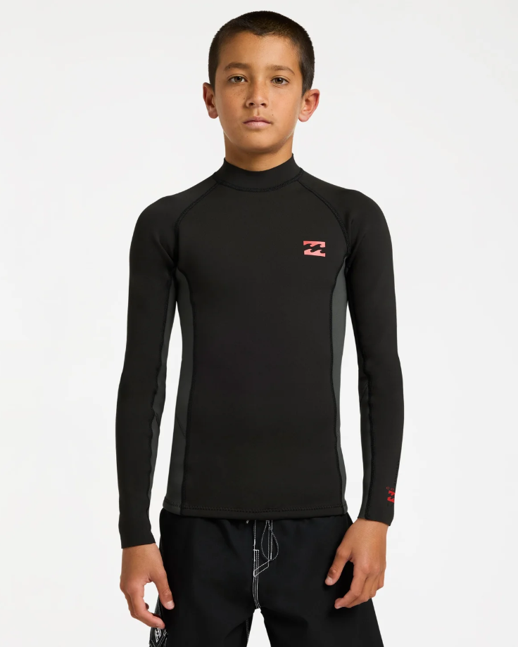 Billabong Absolute 1mm Long Sleeve Boys Wetsuit Vest in tar black on model from the front