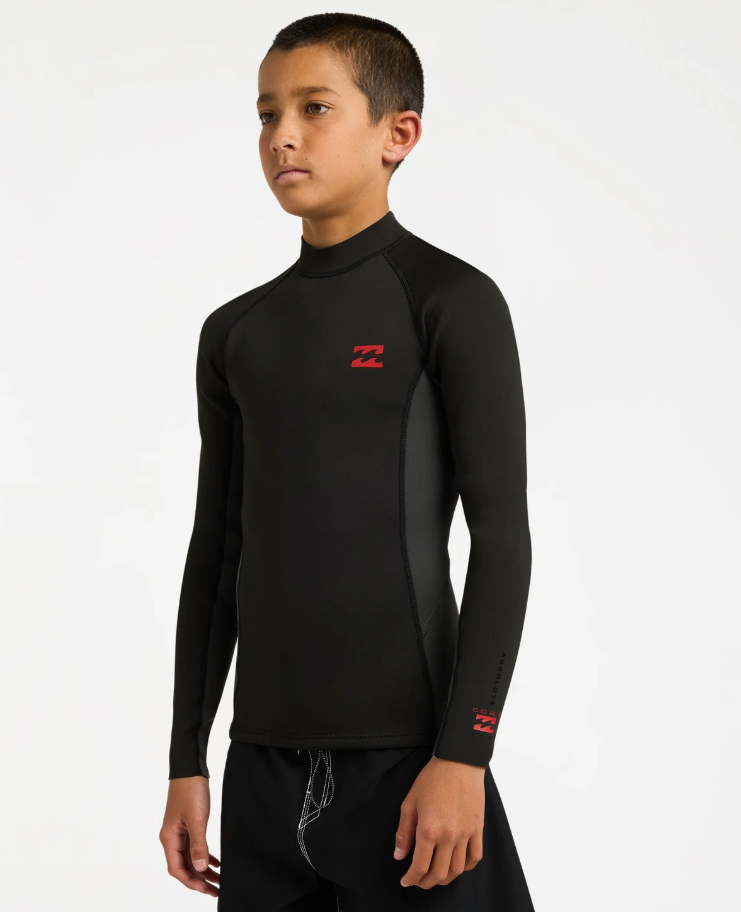 Billabong Absolute 1mm Long Sleeve Boys Wetsuit Vest in tar black on model from the side