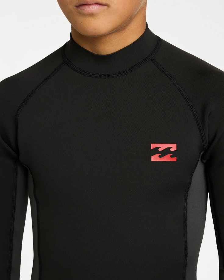 Billabong Absolute 1mm Long Sleeve Boys Wetsuit Vest in tar black on model from the front close up