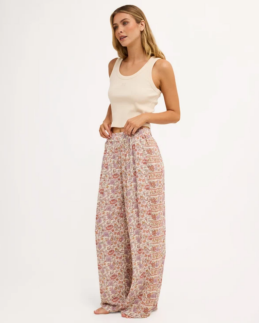 Billabong Forevermore Elastic Waist Pants in multi coloured floral print on blonde model in natural tank from side/front view