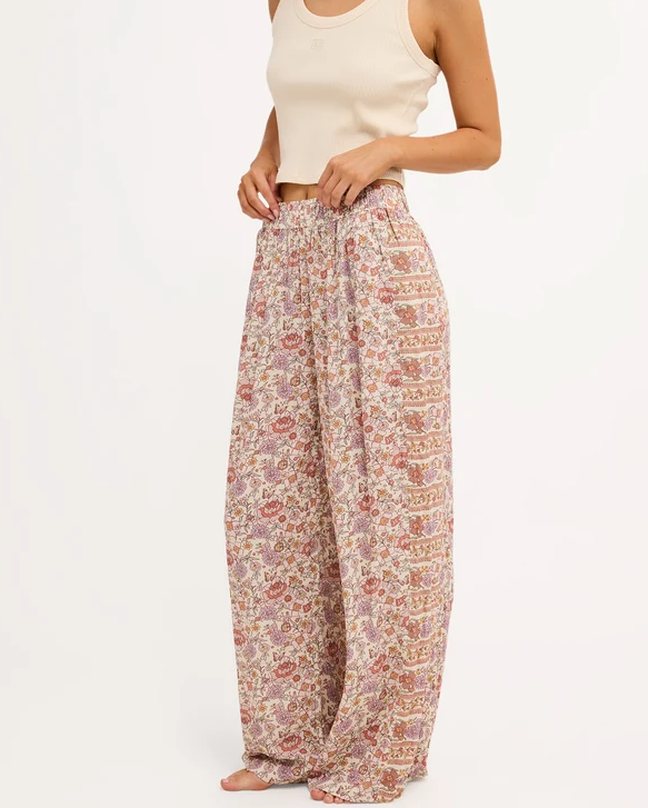 Billabong Forevermore Elastic Waist Pants in multi coloured floral print on blonde model in natural tank from side/front view close up