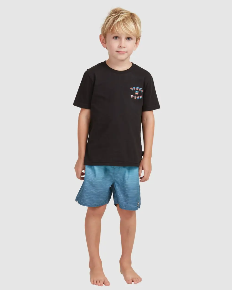 Billabong Groms Sergio Layback Shorts
 in light navy colourway on blond model in black tee from front