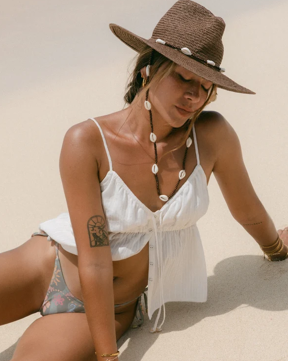 Billabong Till Dawn Camisole Top in salt crystal colourway on model at the beach in straw hat