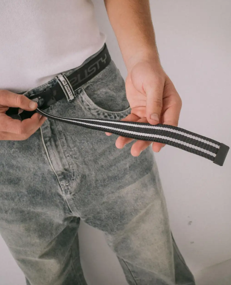 Rusty Flip Daddy Reversible Elastic Webbing Belt in black in model's jeans