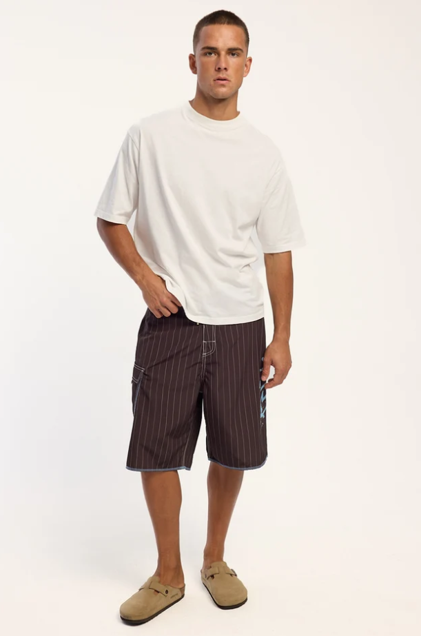 Rusty Scribbla 24" Fixed Waist Boardshorts in java brown with pin stripes on model in white t-shirt