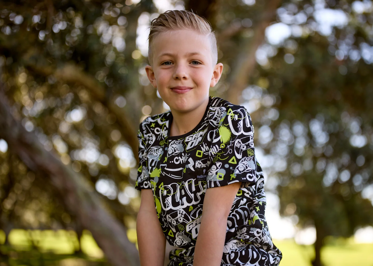 Radicool Kids Gamer Tee on a child by a tree