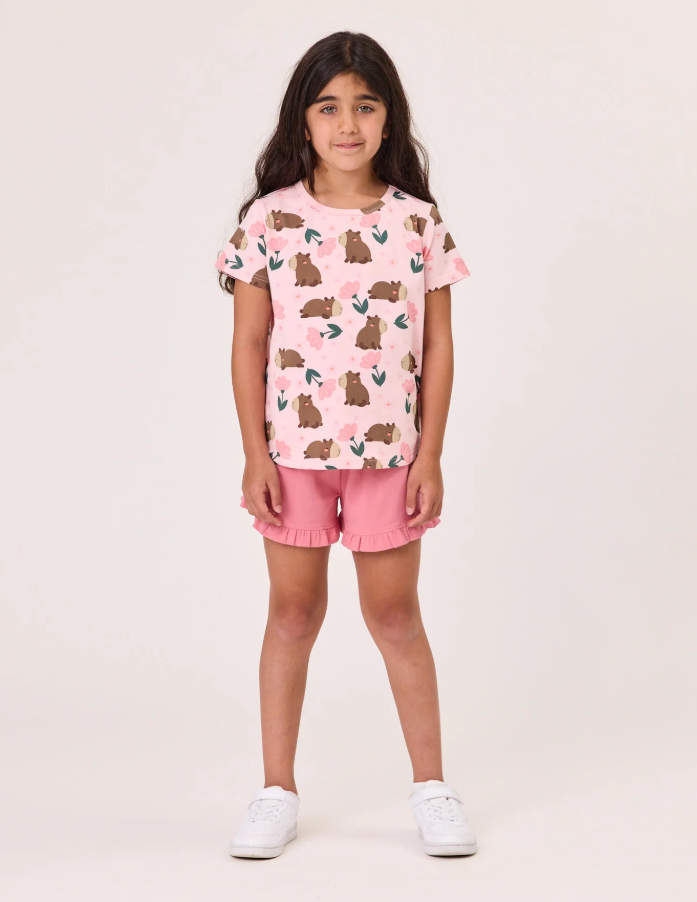 Kissed By Radicool Floral Capybaras Girls Tee in pink on a girl from the front