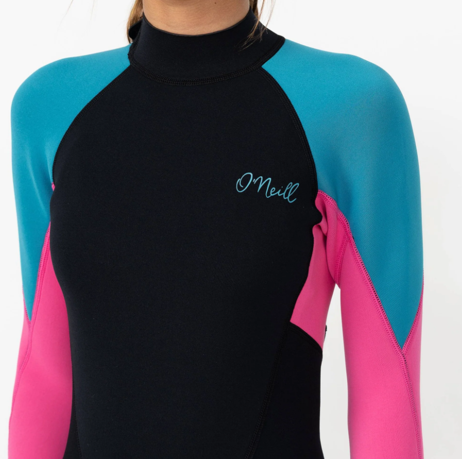 O'Neill Girls 2mm Reactor 2 Long Sleeve Spring Wetsuit in blue curacao colourway with black body and legs, blue shoulders and pink arms on model from the front