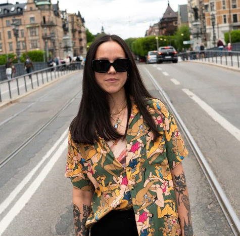 CHPO Brand Hong Kong Sunglasses in black on dark haired model standing in a street