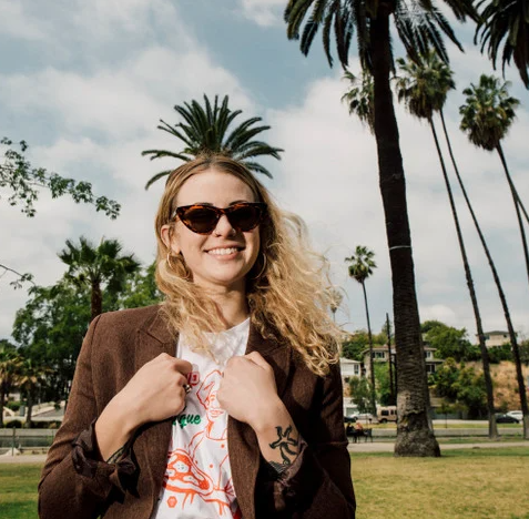 CHPO Brand Amy Turtle Brown Sunglasses on model in brown jacket outside