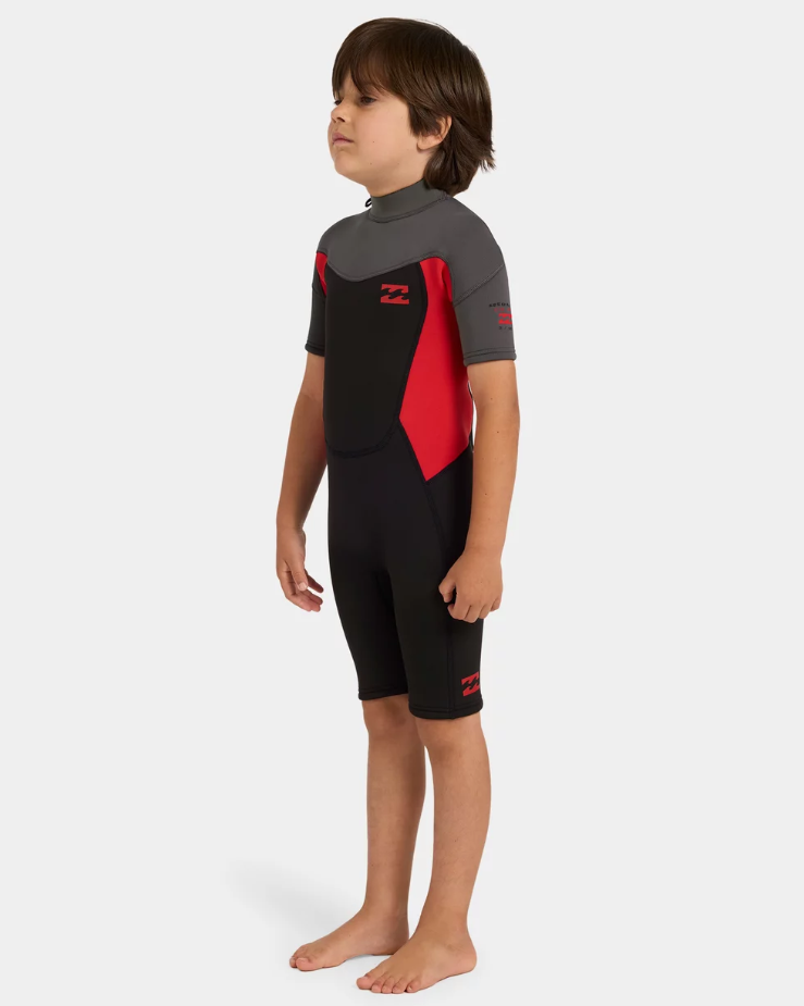 Billabong Absolute 2mm Springsuit Toddler Wetsuit in black, grey and red on kid from the side