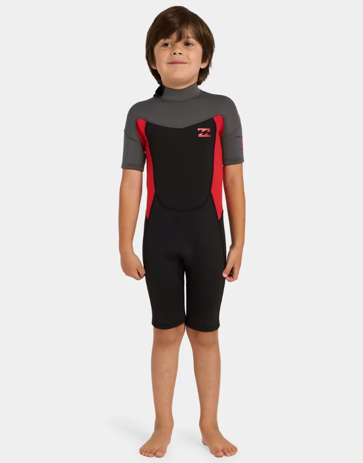 Billabong Absolute 2mm Springsuit Toddler Wetsuit in black, grey and red on kid from the front