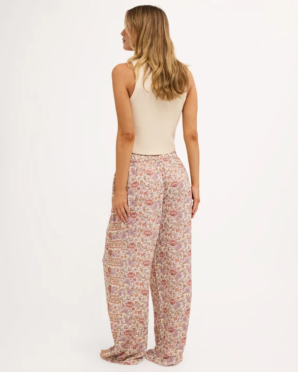 Billabong Forevermore Elastic Waist Pants in multi coloured floral print on blonde model in natural tank from rear view